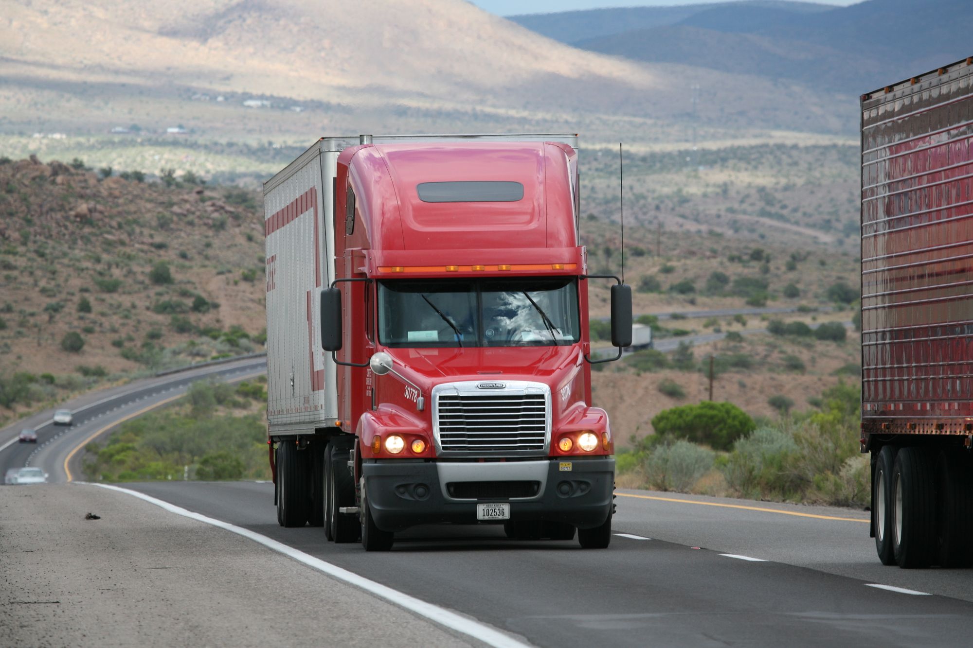 Freight truck travelling along a winding highway